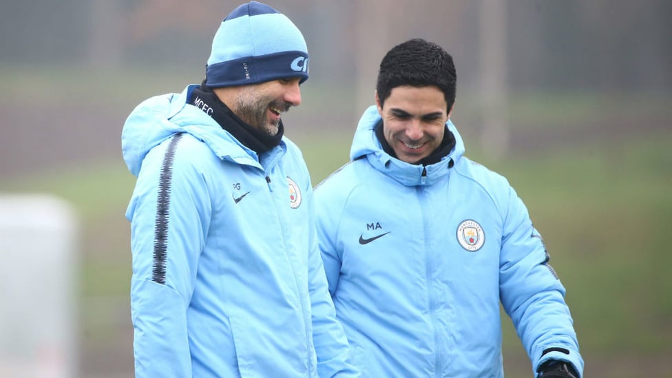 SPRING IN THEIR PEP : Pep Guardiola and Mikel Arteta share a joke during training