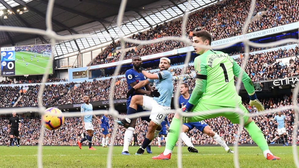 RAMPANT : Aguero slots his side's third goal of the game past Kepa in the Chelsea goal.