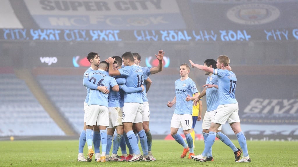 GROUP HUG: The players share the love after Foden's opener.