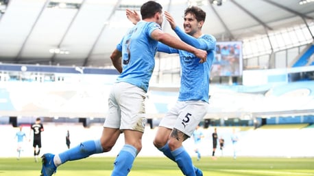 BROMANCE: Stones is the first to congratulate his defensive partner Dias after his goal.