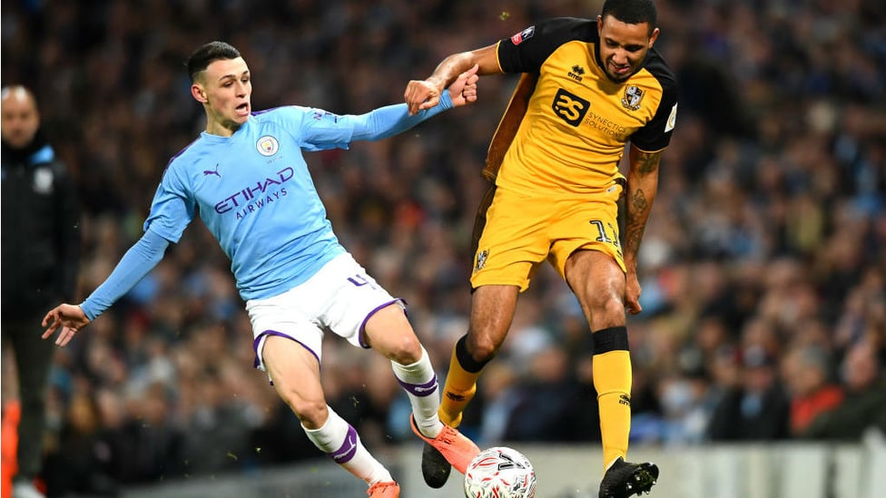 NO QUARTER : Phil Foden vies for possession with Christian Montano