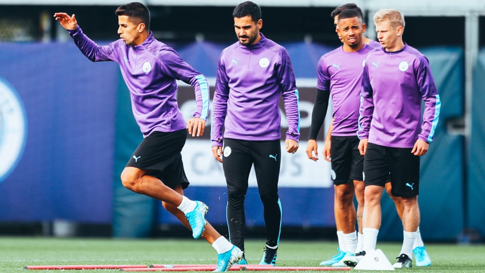 ON THE MOVE : Joao Cancelo sets off on a training drill with Ilkay Gundogan, Gabriel Jesus and Oleks Zinchenko looking on