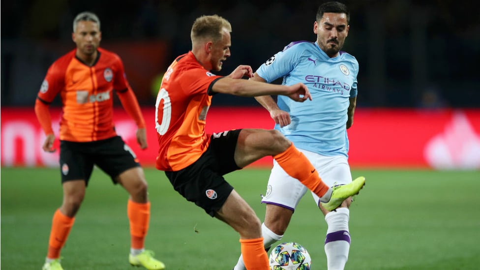 MIDDLE MARCH : Ilkay Gundogan puts the squeeze on the Shakhtar midfield