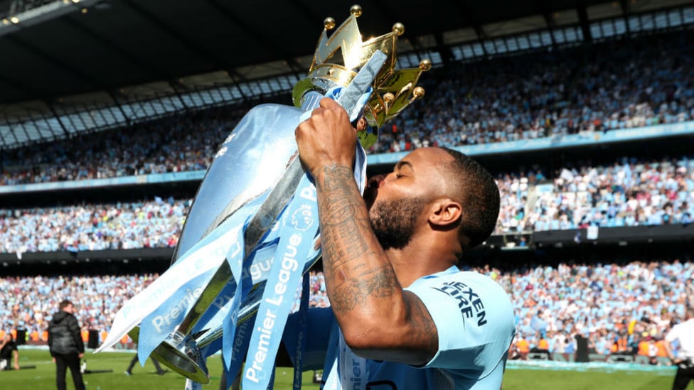 CHAMPIONS : STerling kisses the Premier League trophy.