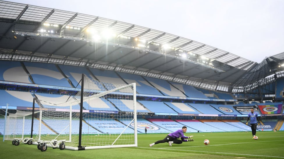 CITY HANDYMAN: Ederson gets down during the pre-match warm-up