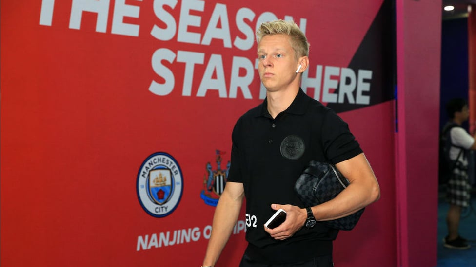 GAME FACE ON : And the backdrop says it all as Oleks Zinchenko heads for the City dressing room