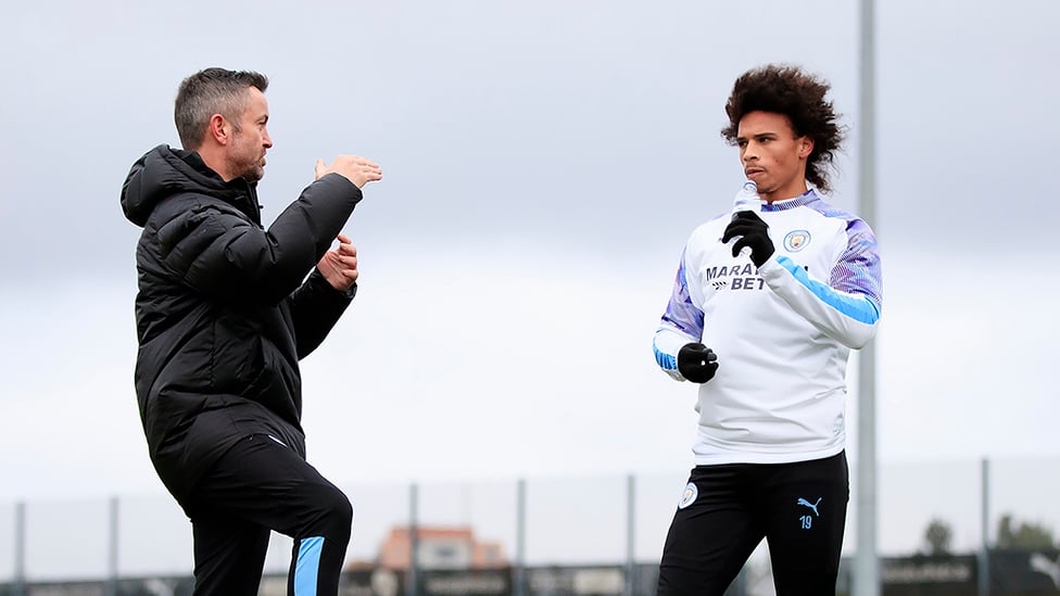 RECOVERY REPORT : Leroy gets advice during his latest session from Donough Holohan, City's sports science strength and conditioning coach