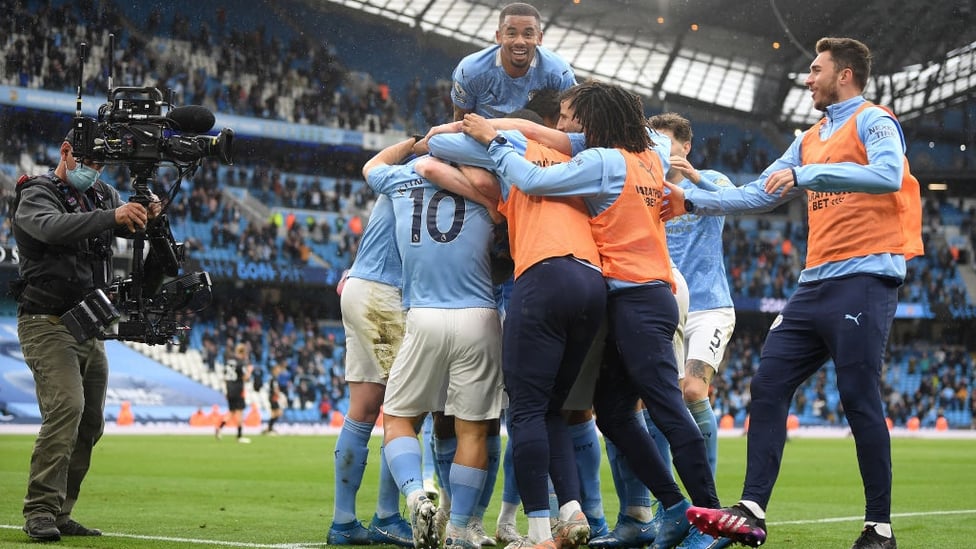 FAIRYTALE ENDING : Aguero is mobbed after grabbing City's fourth.