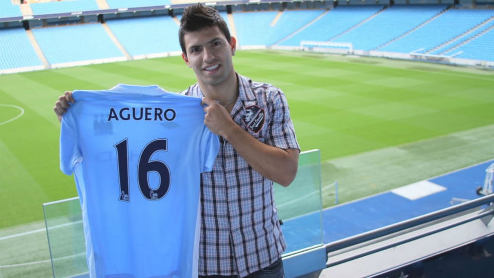 TRUE BLUE : Sergio Aguero proudly shows off his new City shirt after signing for the Club in the summer of 2011