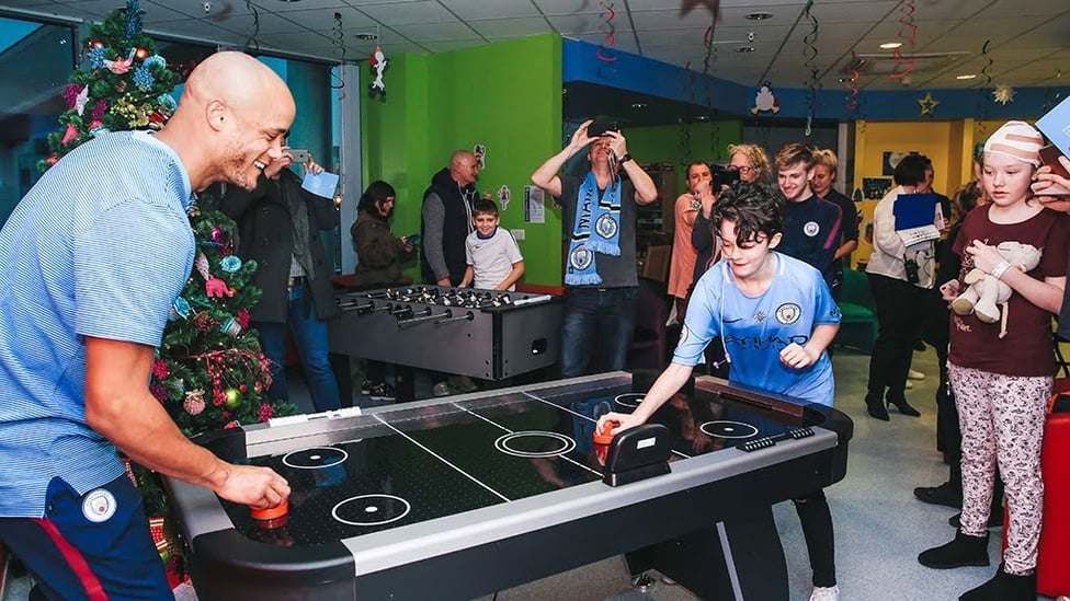 AIR HOCKEY : Our captain has a go at air hockey while on the Christmas hospital visit last year.