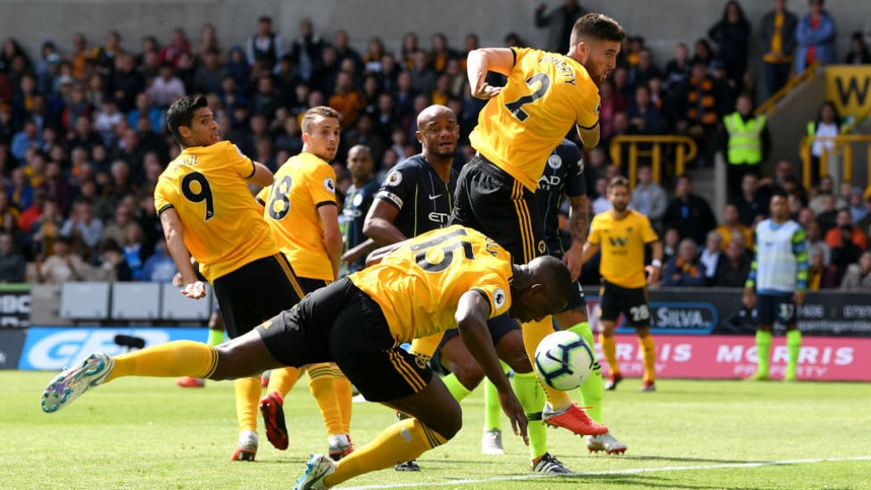 CONTROVERSIAL CALL : Willy Boly stoops to open the scoring for Wolves but replays showed the ball went in off his hand