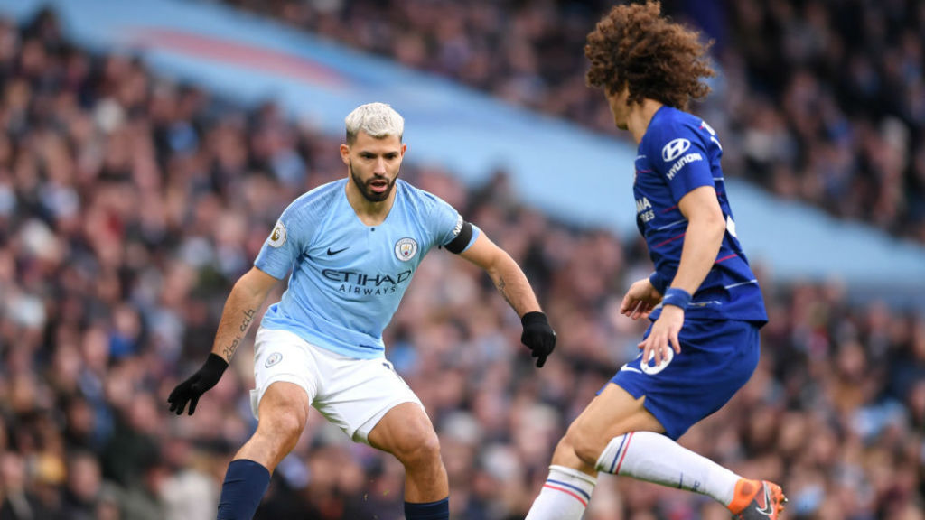 Sergio Aguero takes on David Luiz.