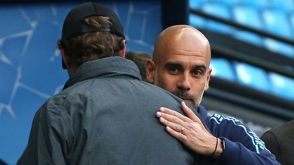 TACTICIANS : Guardiola and Klopp share a warm embrace before the match begins.