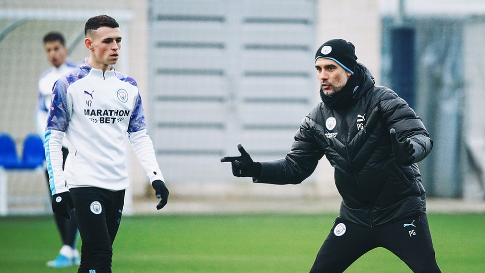 MASTER AND APPRENTICE : Phil Foden listens to Pep's advice...