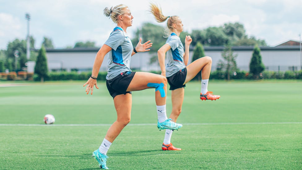 A GOOD OLD 'KNEES=UP!' : Alex Greenwood and Esme Morgan stretch the legs!