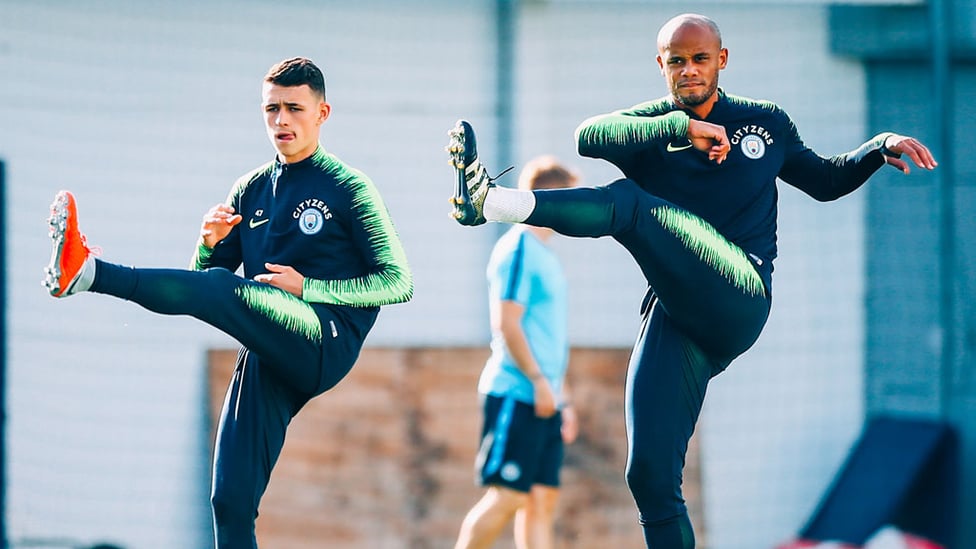 YOUTH AND EXPERIENCE : Phil Foden and skipper Vincent Kompany warm up