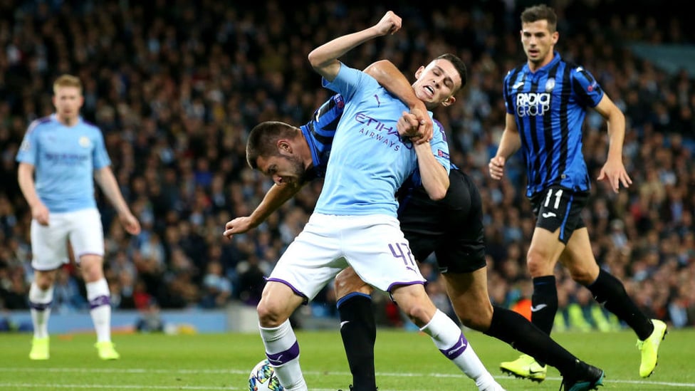 ROYAL RUMBLE : Foden is hauled down inside the area