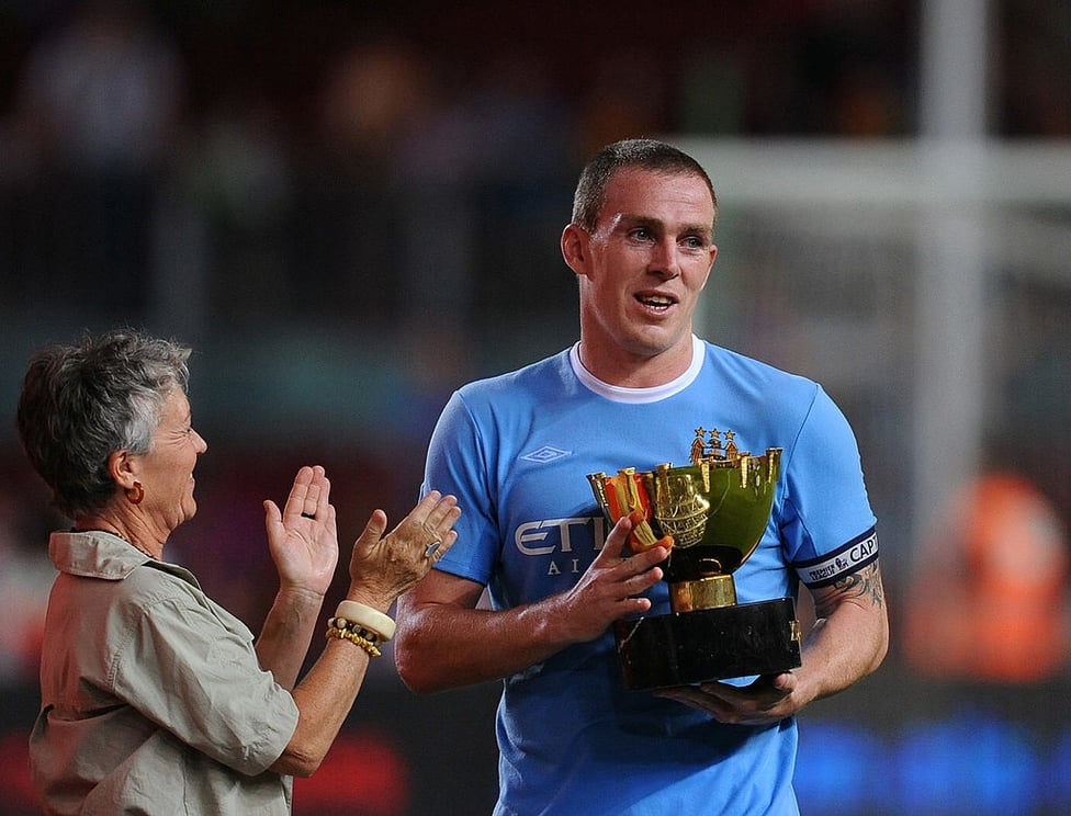 Notable feat : Dunne is presented with the Joan Gamper Trophy after City's 1-0 win over Barcelona at the Nou Camp