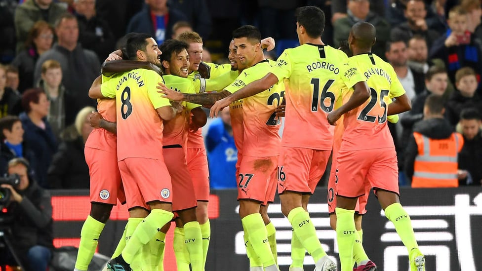 GROUP HUG : The players share the love after the spectacular second goal.