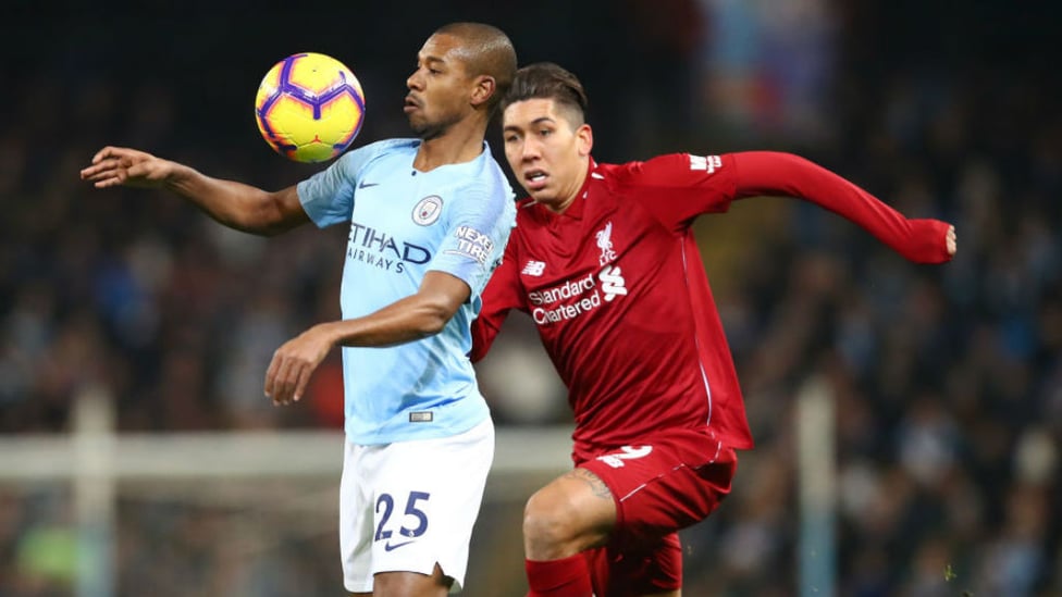 BRAZILIAN BLEND : Fernandinho shields the ball from Brazil team-mate Roberto Firmino