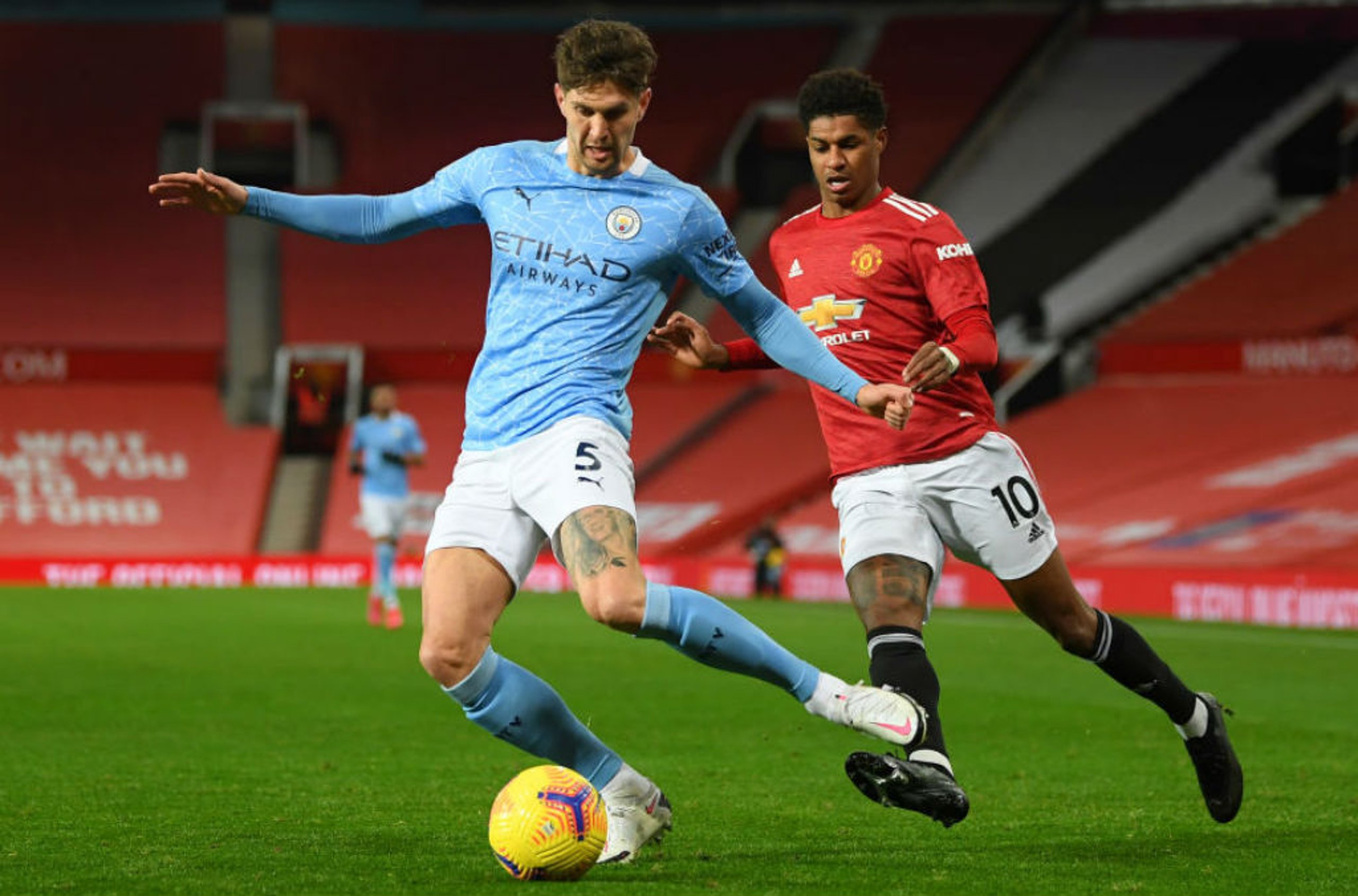 CENTRE OF ATTENTION: John Stones snuffs out the threat of Marcus Rashford