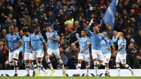 SQUAD GOALS: The team get together to celebrate the late winner. 