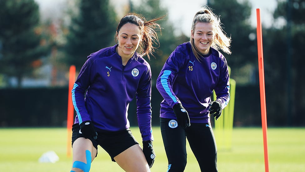 ON THE MOVE : Megan Campbell and Lauren Hemp limber up ahead of the West Ham clash