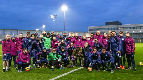 SQUAD: The team pose for a photo with Guardiola's Manager of the Month award after training