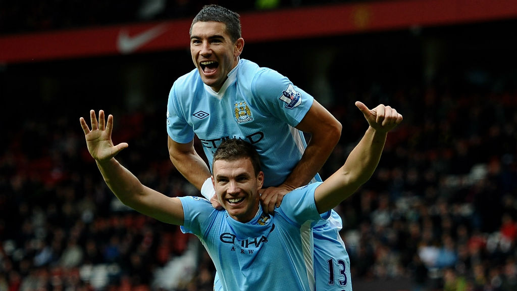 SIX APPEAL: Edin Dzeko celebrates after sealing City's remarkable 6-1 demolition derby win at Old Trafford in October 2011