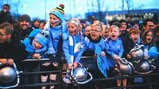 YOUNG AT ART: These excited City fans get ready to greet their heroes