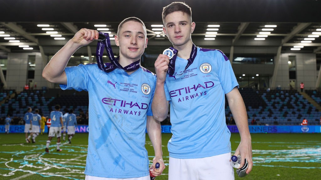 Joe Hodge (left) celebrates Manchester City's 2019/20 U18 Premier League Cup win.