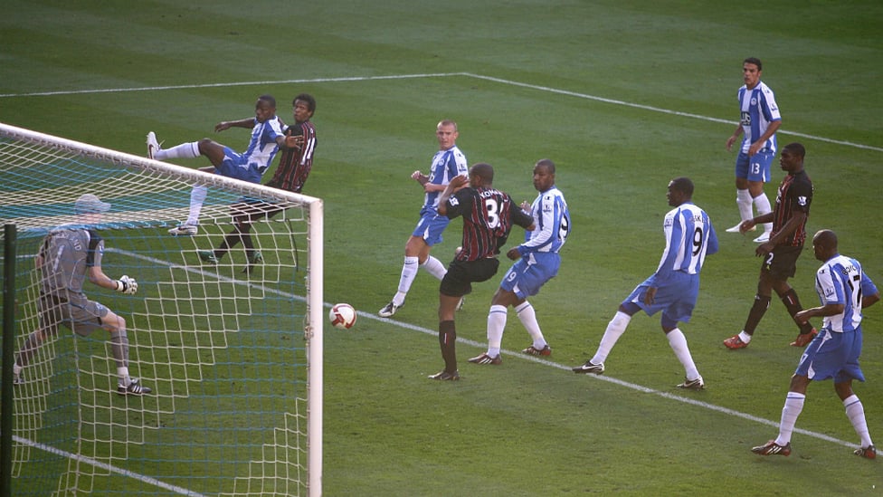 TAP IN : Kompany squeezes the ball in for his first City goal against Wigan in 2008