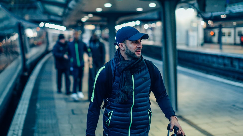 HAT TRICK : Kyle Walker sports a nifty looking baseball cap as he steps off the train at Euston