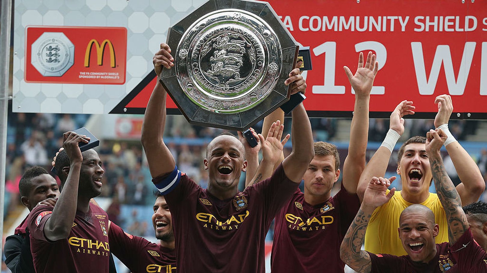ALL SMILES: Vincent Kompany lifts the Community Shield as City celebrate after our 3-2 victory over Chelsea in 2012