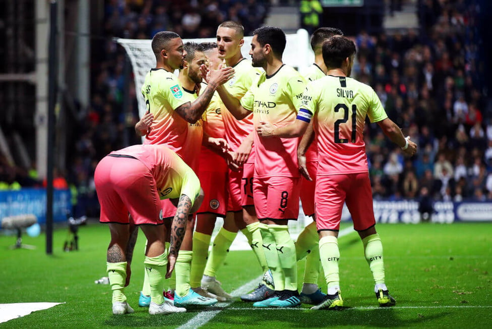 GROUP HUG : The boys share the love after blowing Preston away in the first half