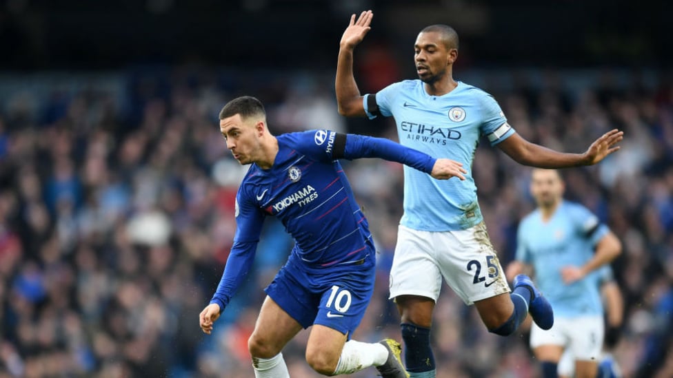 BATTLE : Fernandinho and Eden Hazard come head-to-head in the middle of the park.