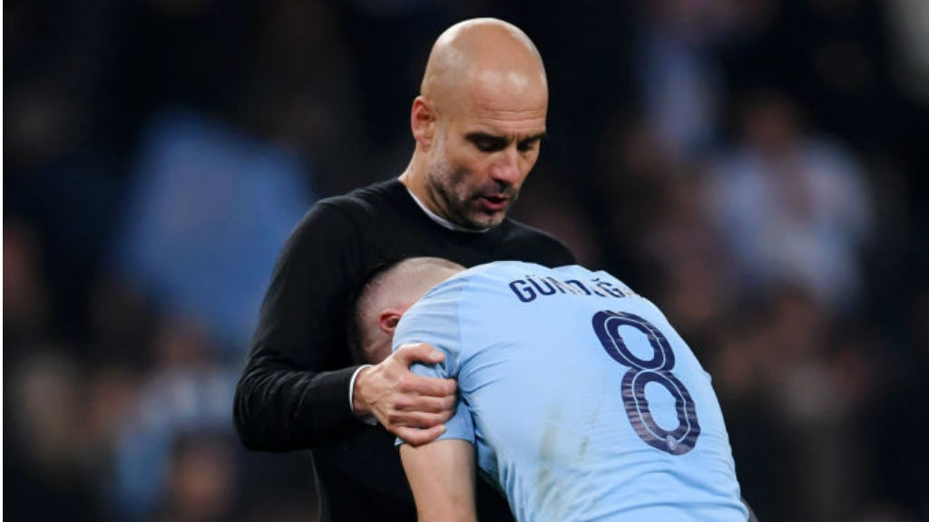 AGONY: Pep Guardiola consoles Ilkay Gundogan after the final whistle