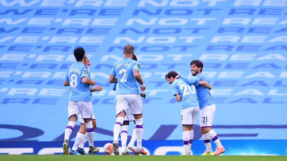 CAPTAIN FANTASTIC : The players rush to congratulate the skipper after his superb goal.