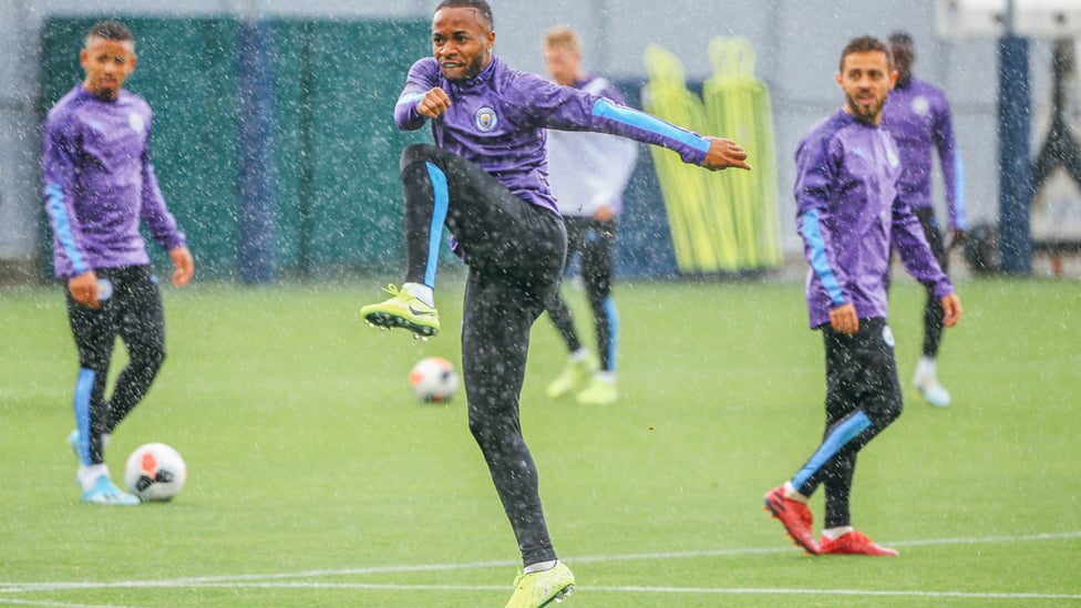 RAINY CITY : The lads get soaked during a downpour