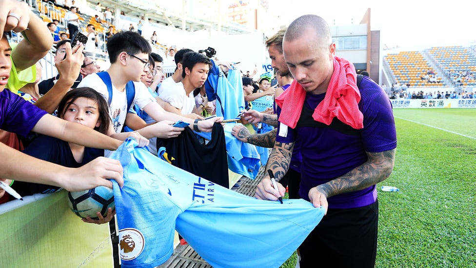 PEN PALS : Angelino and his team-mates stop to sign autographs