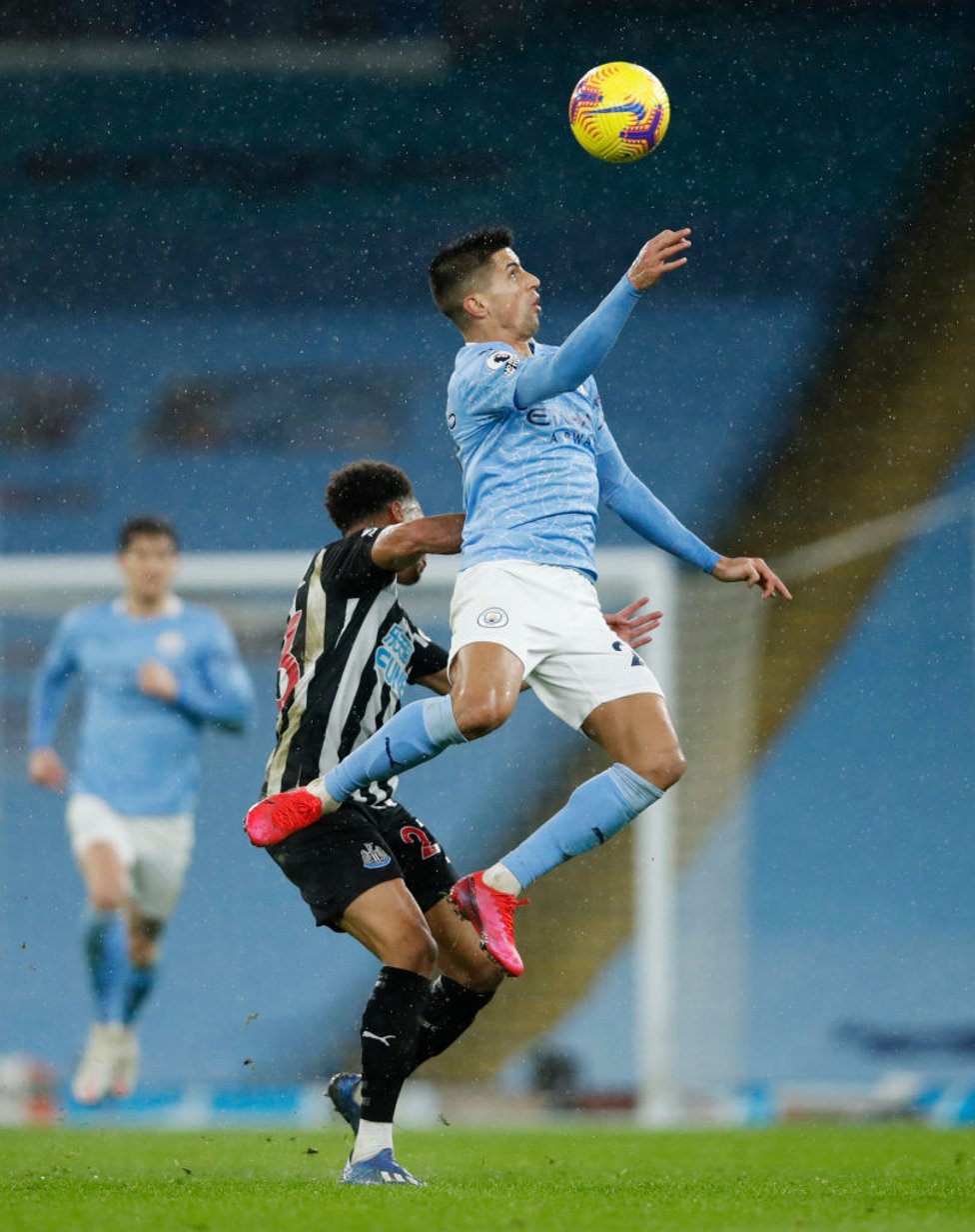 HEADS UP : Cancelo rises highest to head the ball clear.