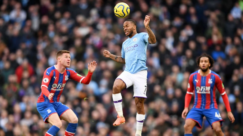 HEADS UP : Sterling leaps highest to flick the ball on.