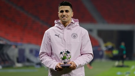 STAR MAN: Cancelo receives his award after a superb display.