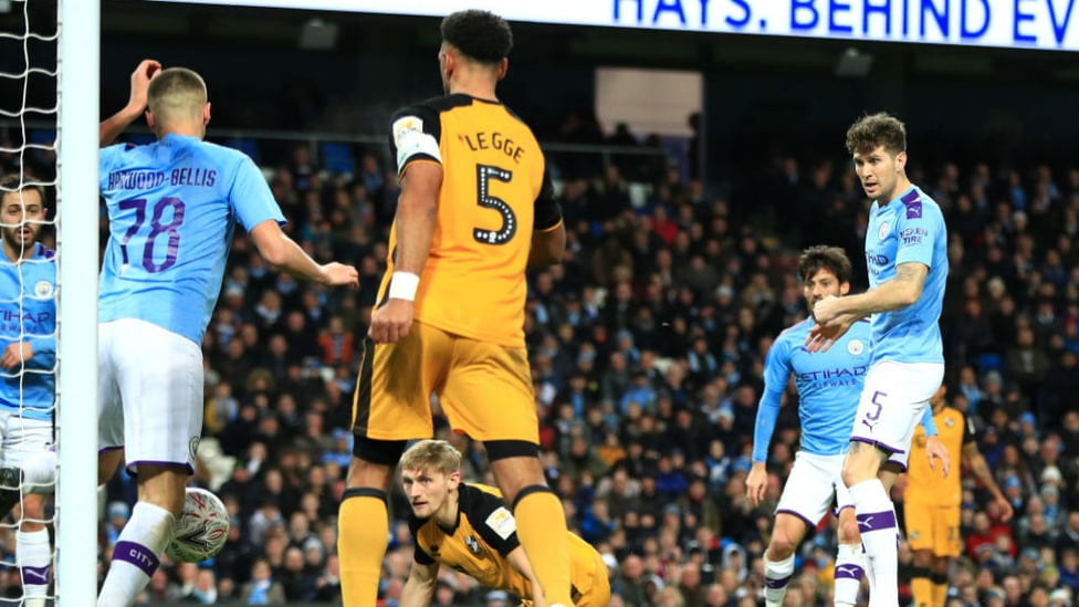 THREE CHEERS : Taylor Harwood-Bellis deflects home John Stones' shot for City's third goal