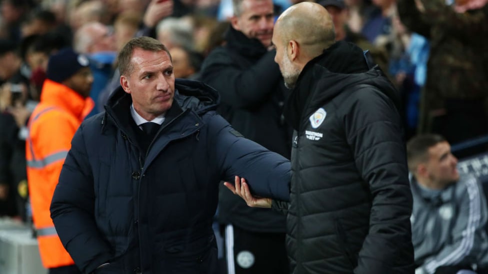 TACTICIANS : The managers embrace ahead of kick-off.