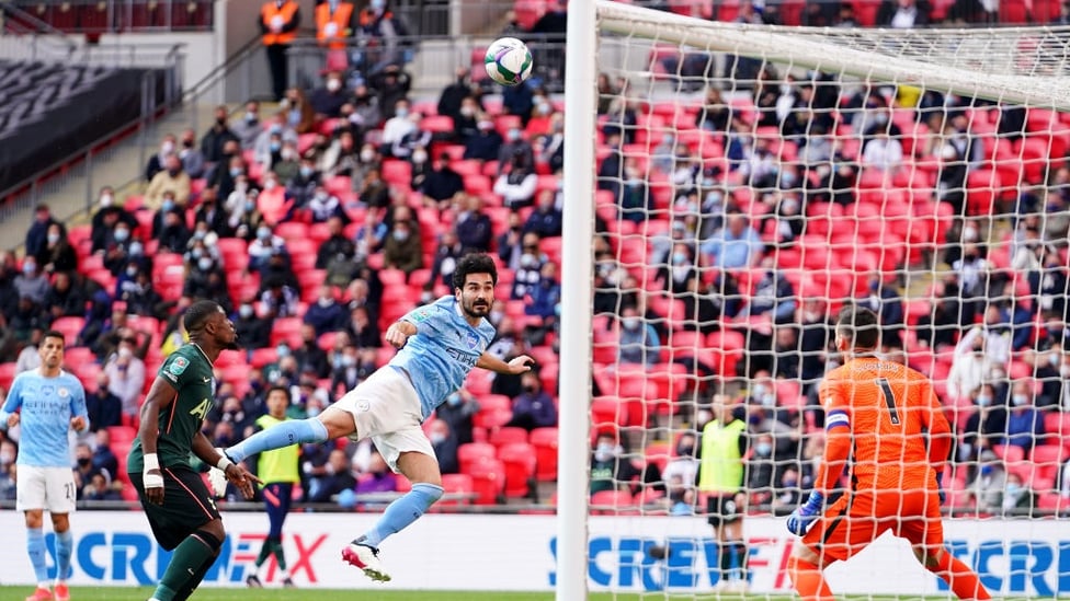 STRETCH : Gundogan pulls every muscle to reach the ball but his header loops over in the second half.