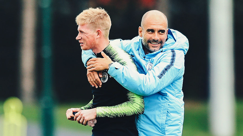 GIVE US A HUG: Pep Guardiola wraps his arms around Kevin De Bruyne