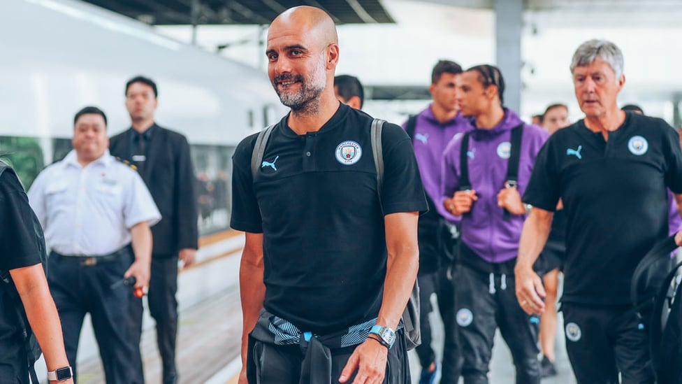 THE BOSS : Pep looks relaxed as he boards the train to Nanjing.