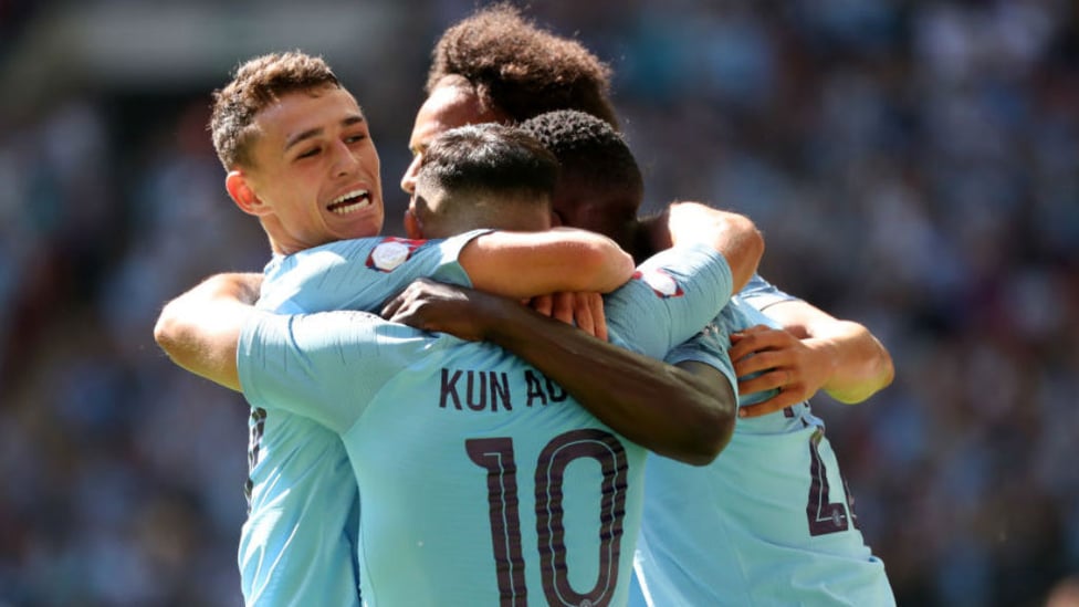 ALL SMILES : Phil Foden leads the celebrations after Sergio Aguero netted his 200th goal for City