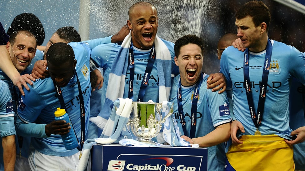 ALL SMILES : The team prepare to lift the League Cup trophy in 2014